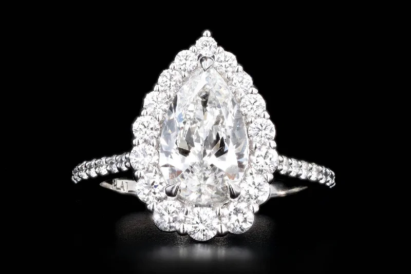 1.83 Carat Pear Diamond Graduated Halo Engagement Ring in Platinum GIA Certified